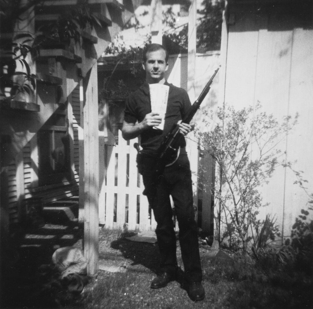 An early photo of Oswald with a rifle